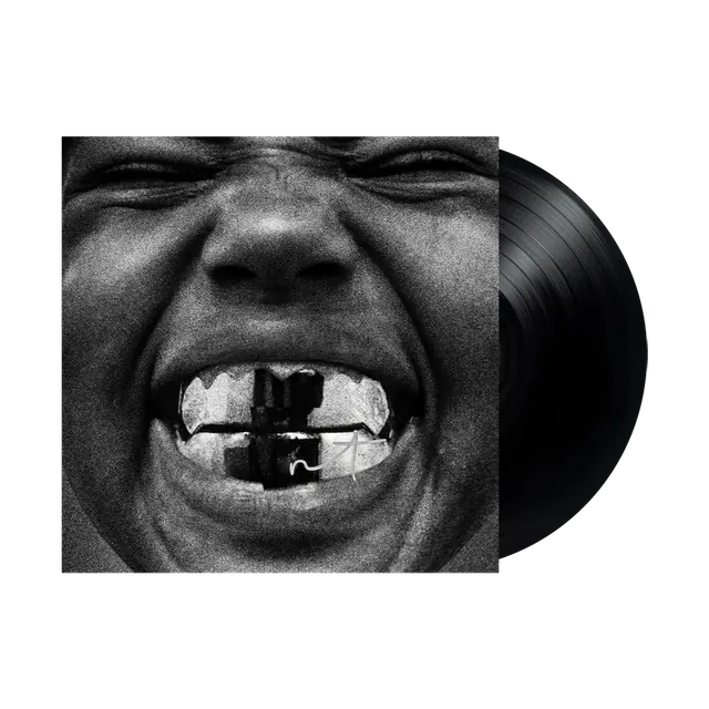 Signed Bully LP — the black-and-white grill-face sleeve with a signature scrawled across the teeth, black record sliding out the side.